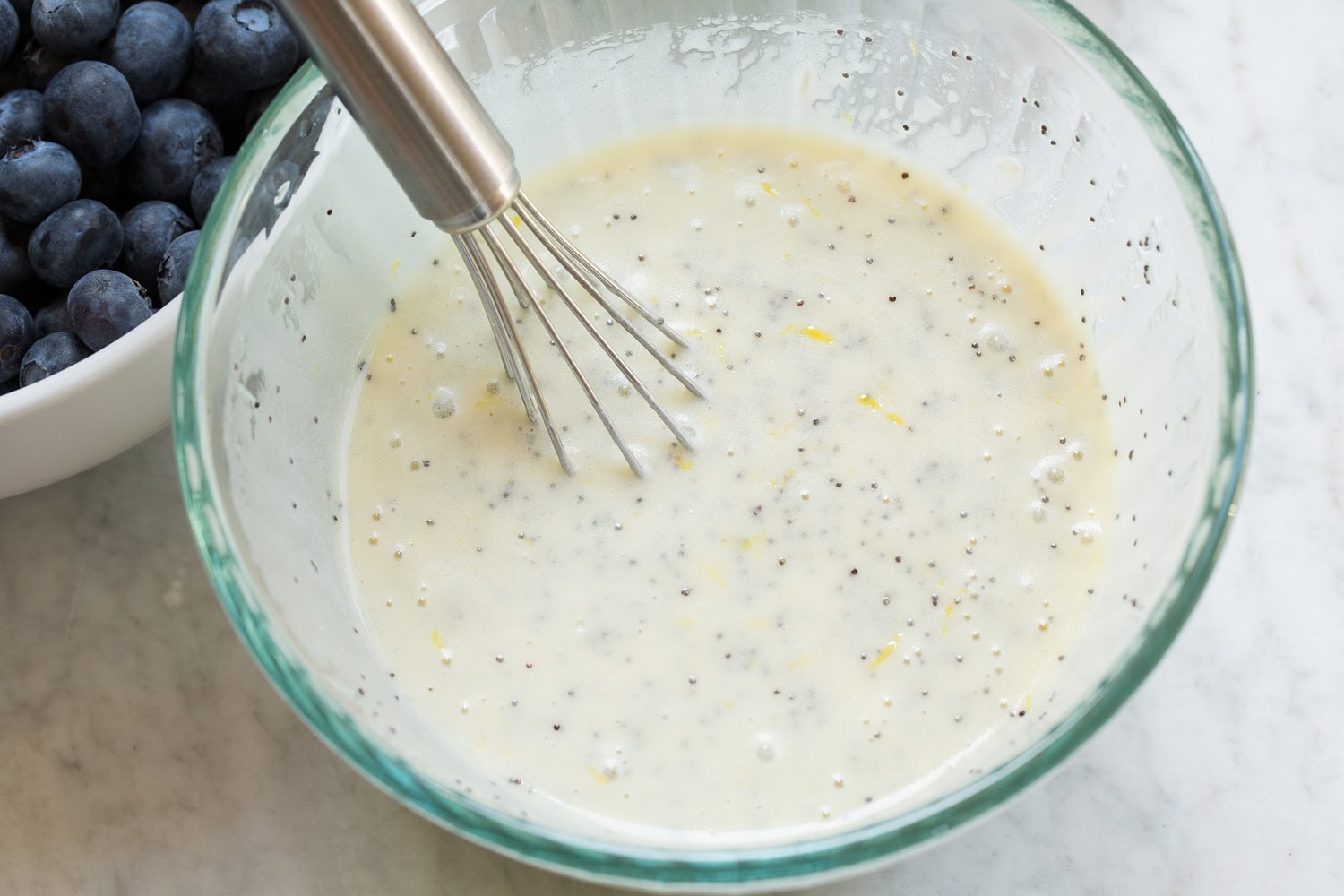 Creamy lemon poppy seed dressing shown after mixing.