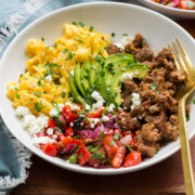 Breakfast bowl made with turkey sausage, scrambled eggs, pico, avocado and feta.