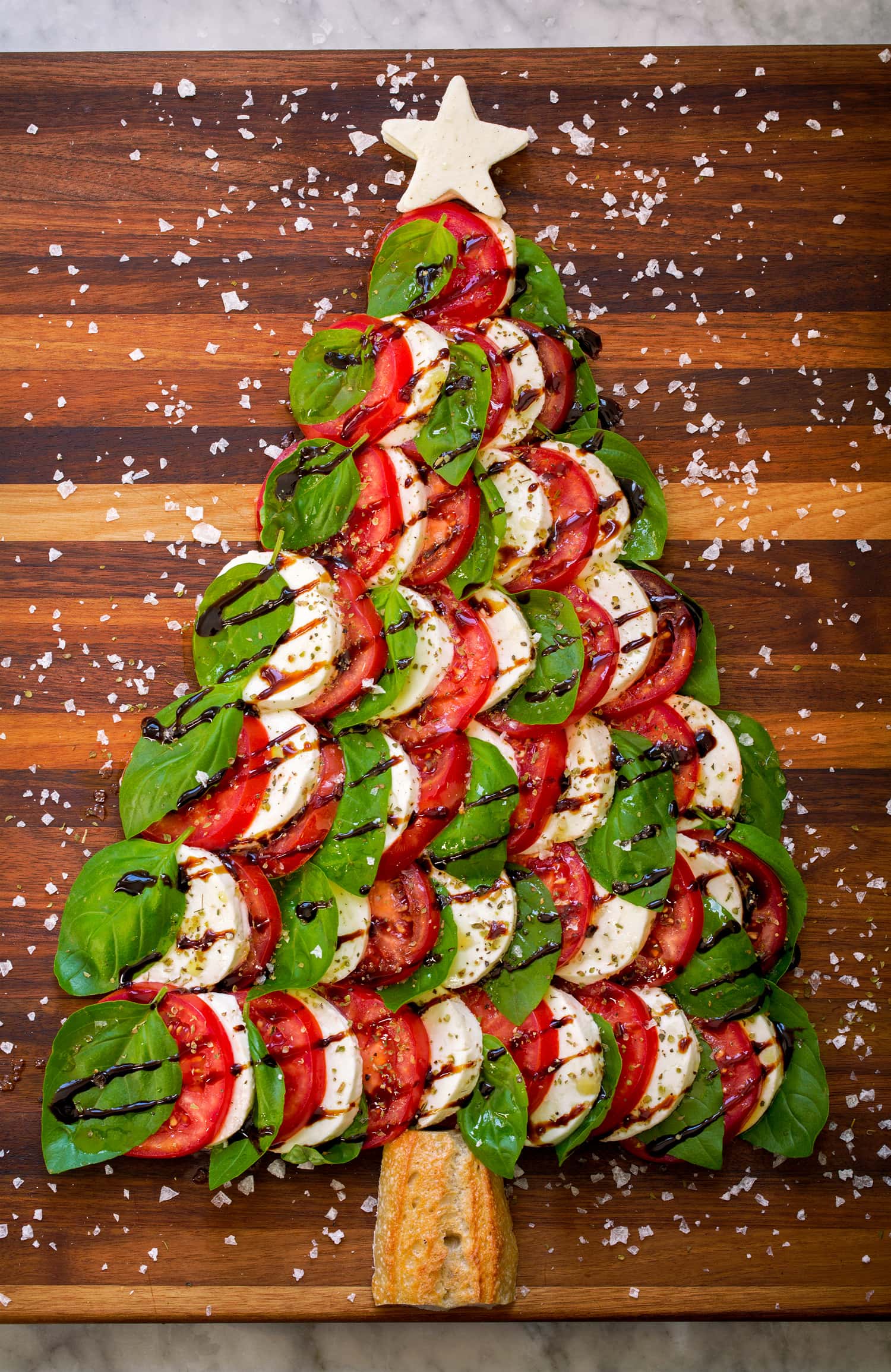 Caprese Christmas Tree Caprese Christmas tree with fresh mozzarella, tomato slices, fresh basil leaves, balsamic glaze and sea salt flakes.