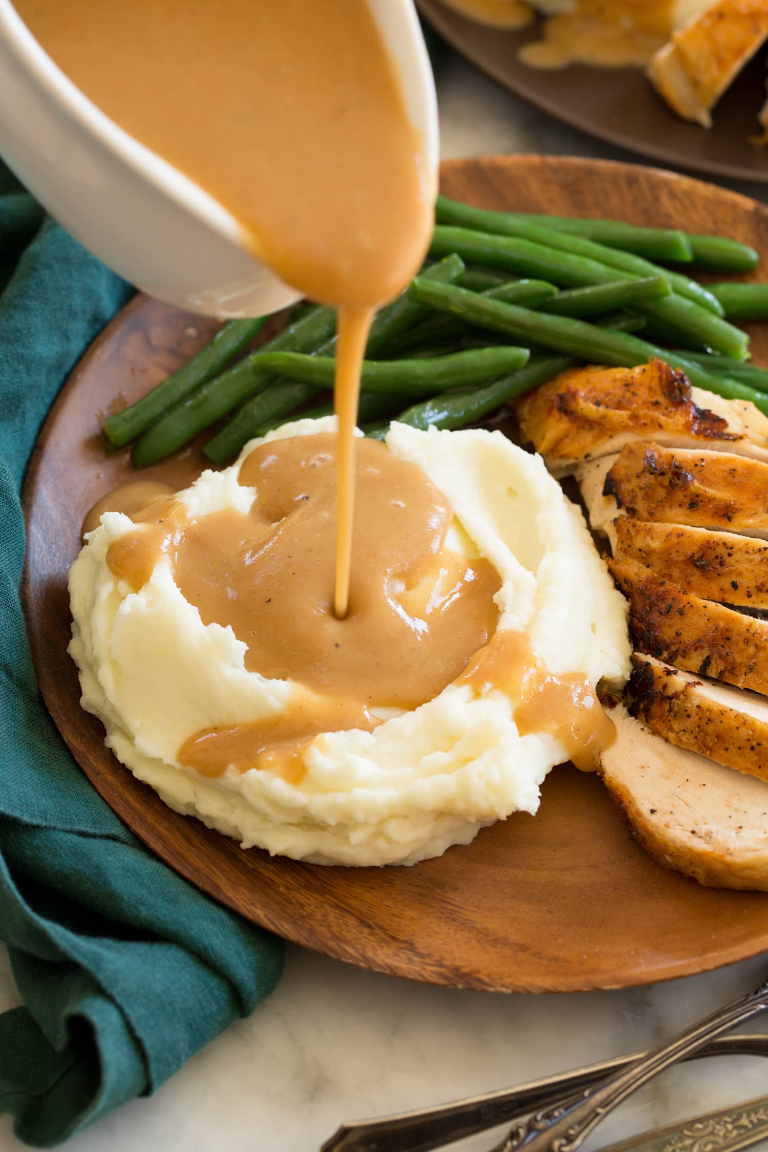 Chicken Gravy Gravy being poured over mashed potatoes.