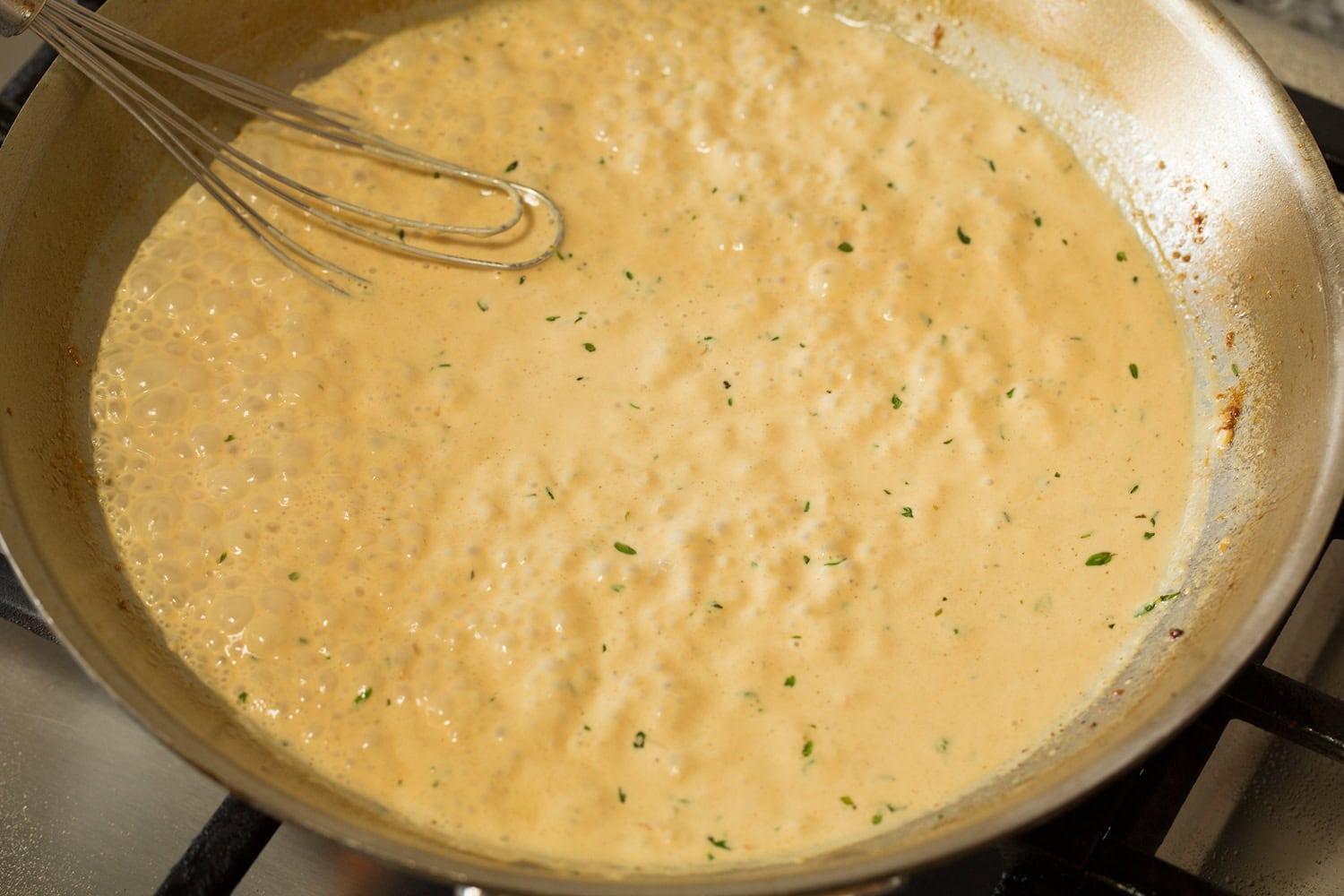 Mixed finished creamy mustard sauce shown in skillet.
