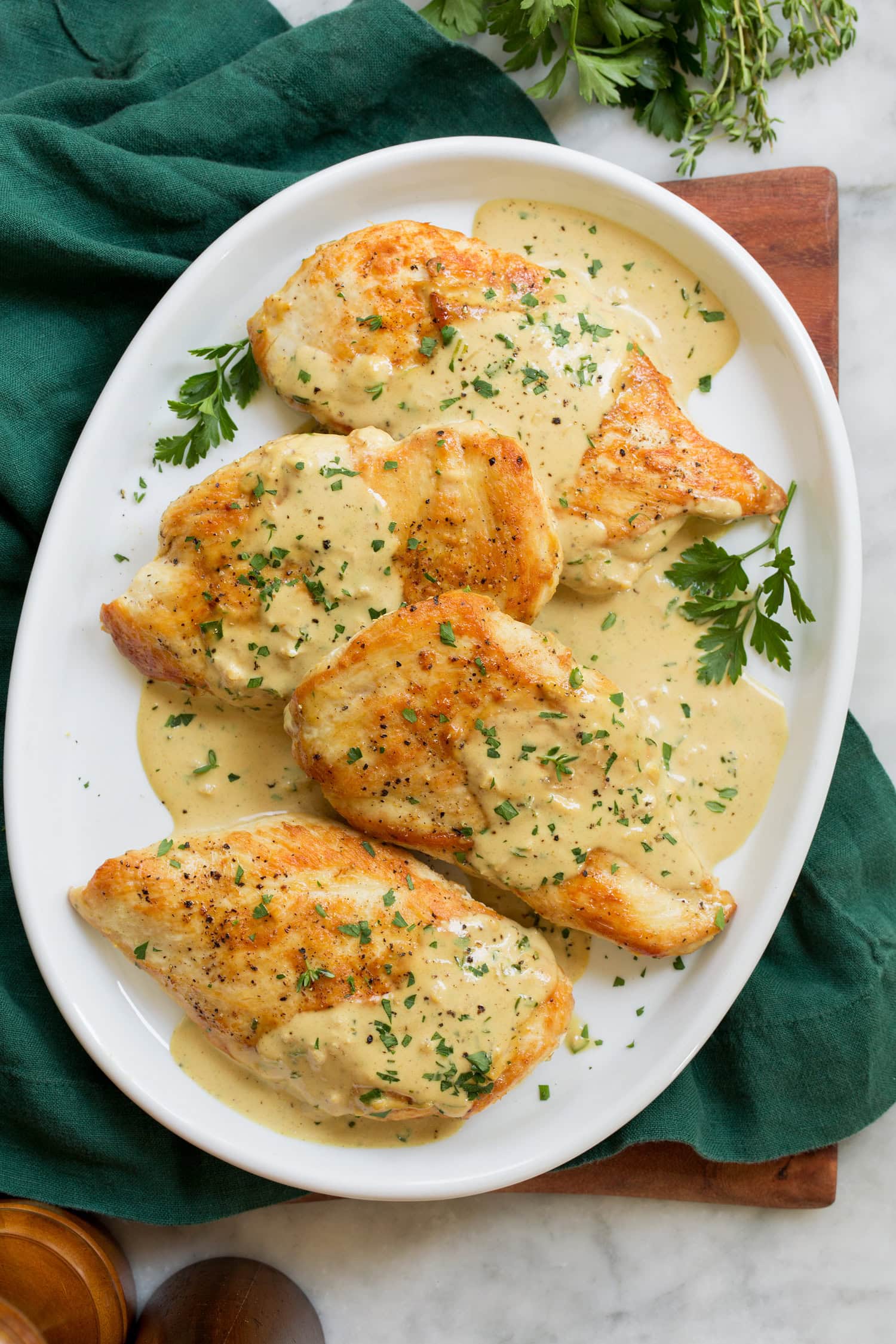 Overhead photo of four pieces of chicken with mustard sauce.