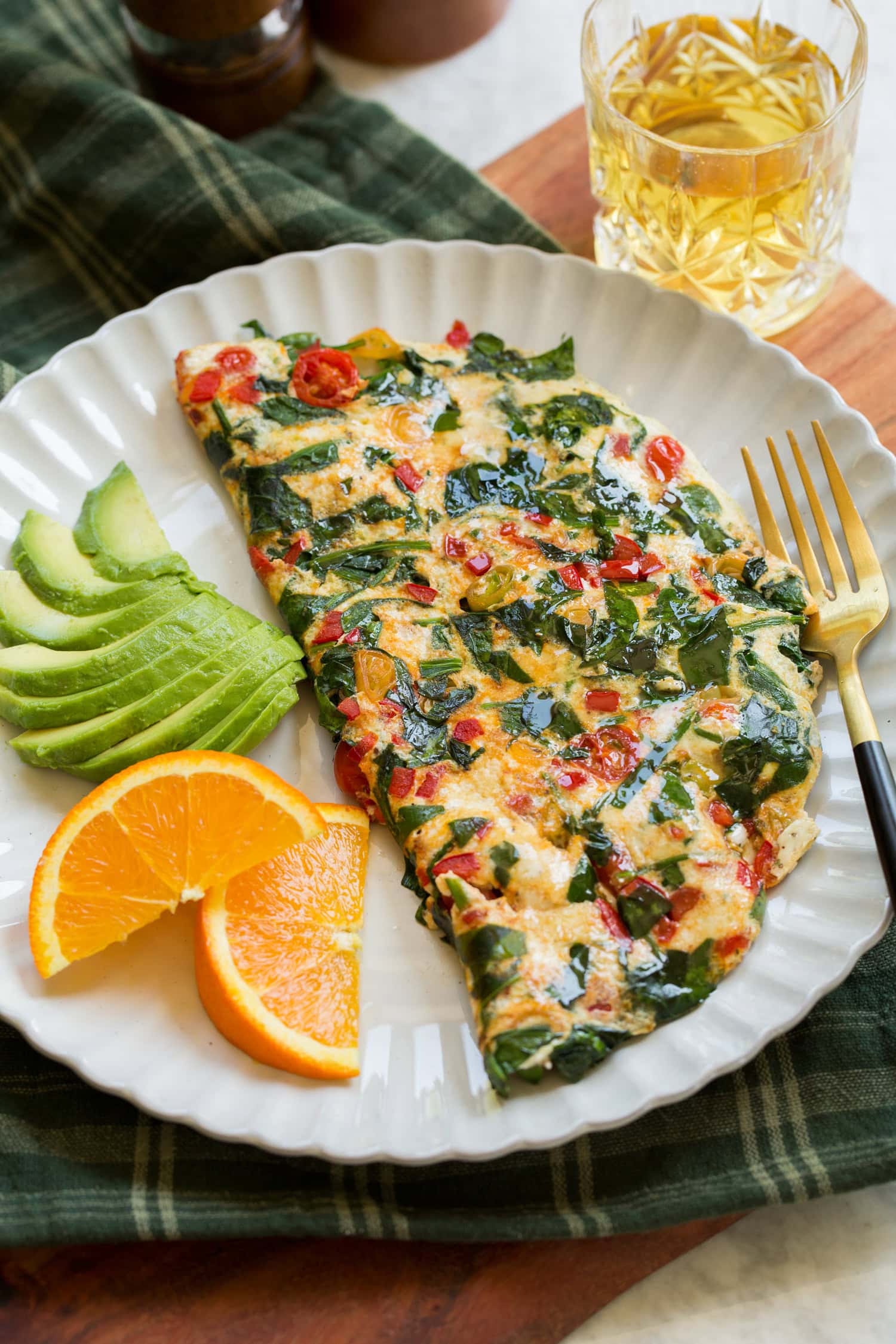 Egg White Omelette Healthy egg white omelette served with avocado slices and sliced oranges.