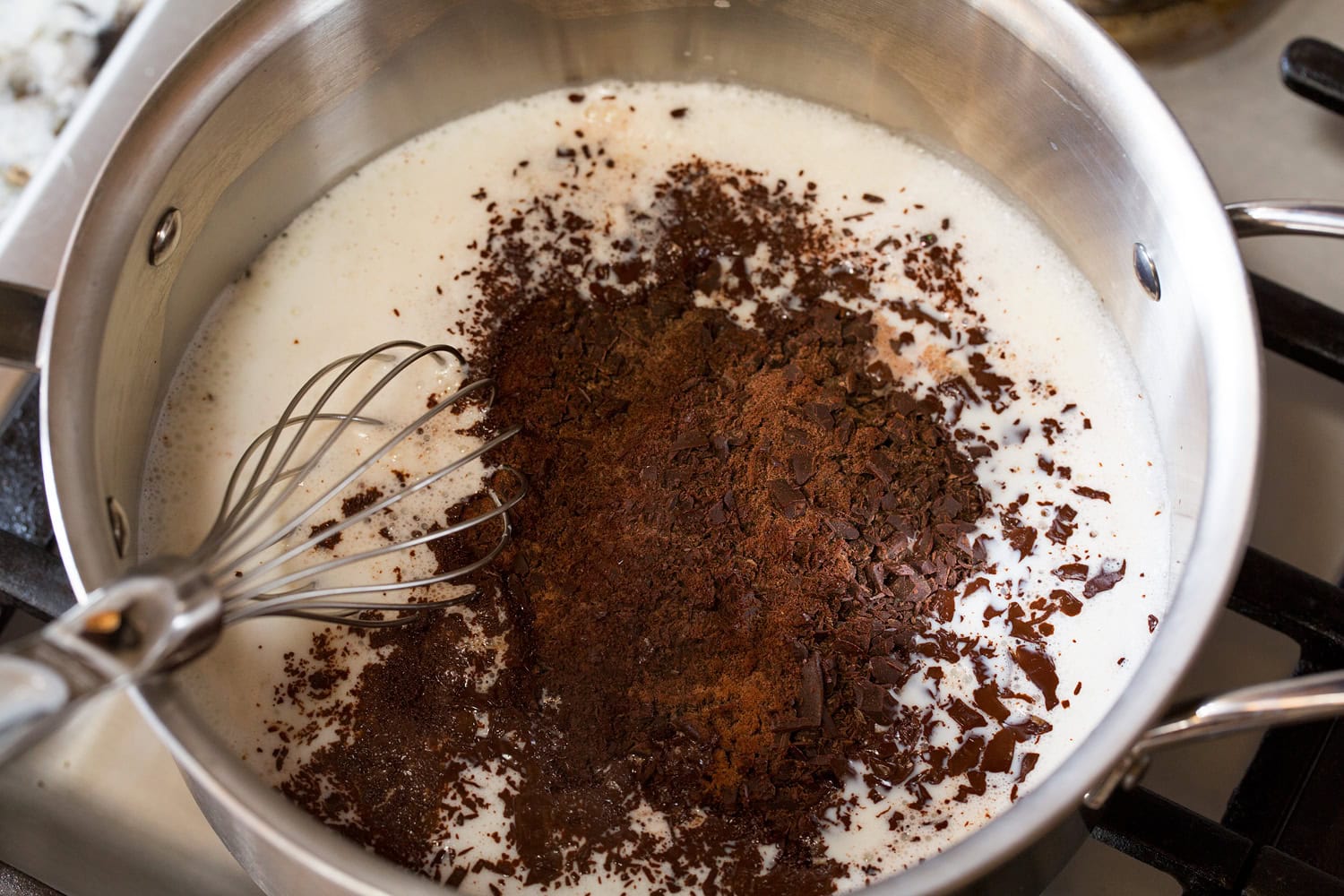 French Hot Chocolate Chopped chocolate added to milk in saucepan.