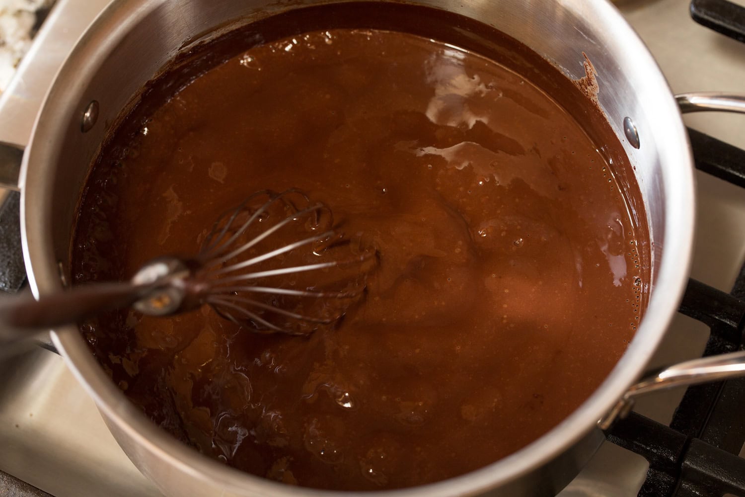 French Hot Chocoalte Finished French hot chocolate in saucepan with whisk.