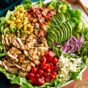 Grilled chicken salad with chicken, bacon, tomatoes, corn, avocado, romaine, red onion and feta.