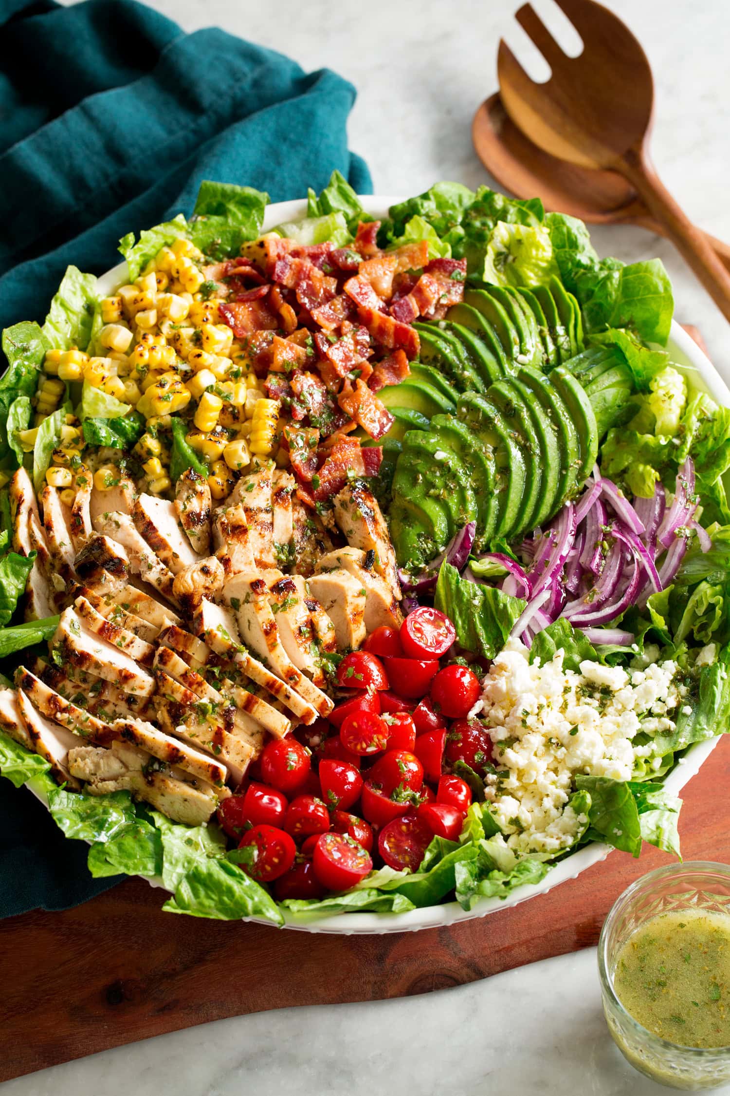 Grilled Chicken Salad Grilled chicken salad with chicken, bacon, tomatoes, corn, avocado, romaine, red onion and feta.