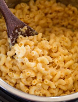 Close up image of mac and cheese being scooped from Instant Pot.