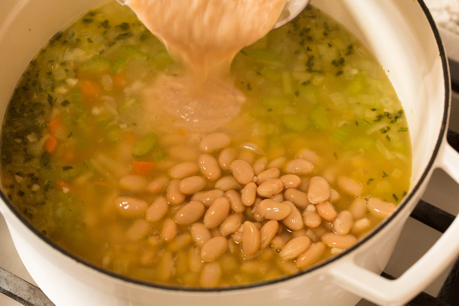 Whole white beans and bean puree added to soup.