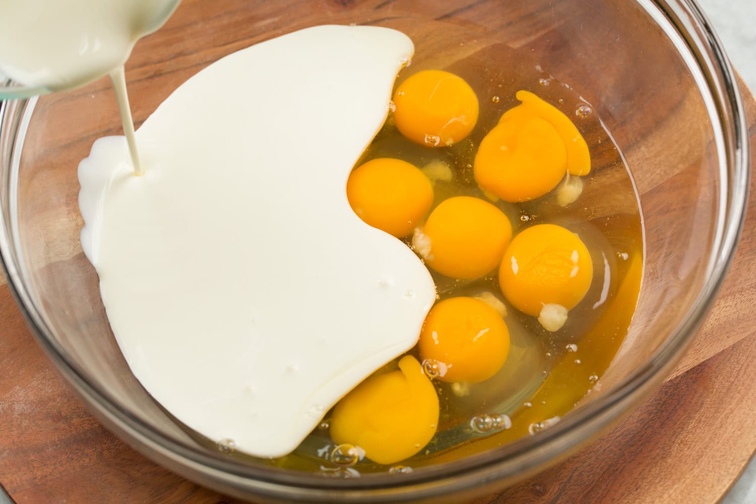 Mini Quiche Eggs and cream in mixing bowl.