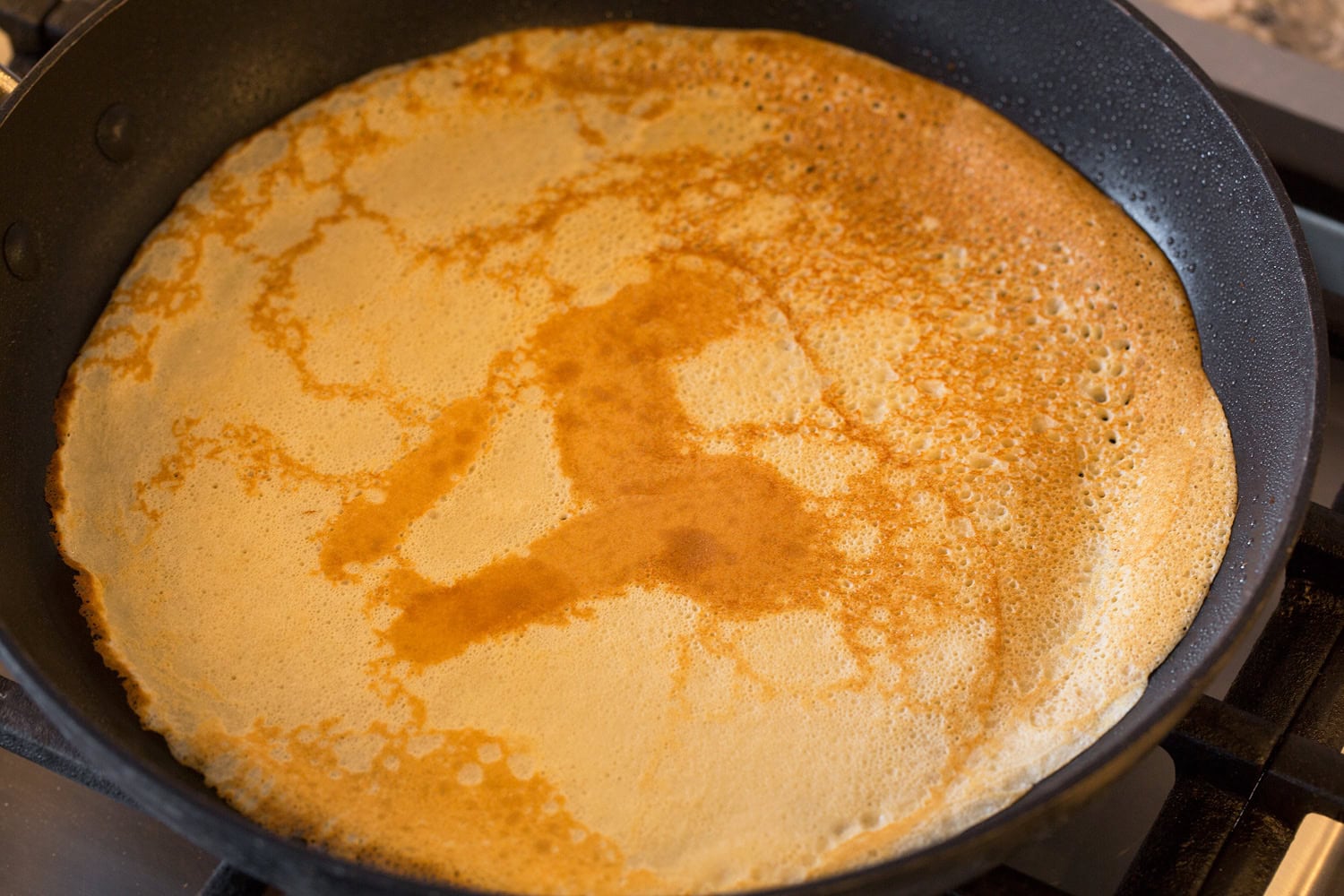 Healthy Oat Crepes Healthy oat crepe in pan shown after flipping.