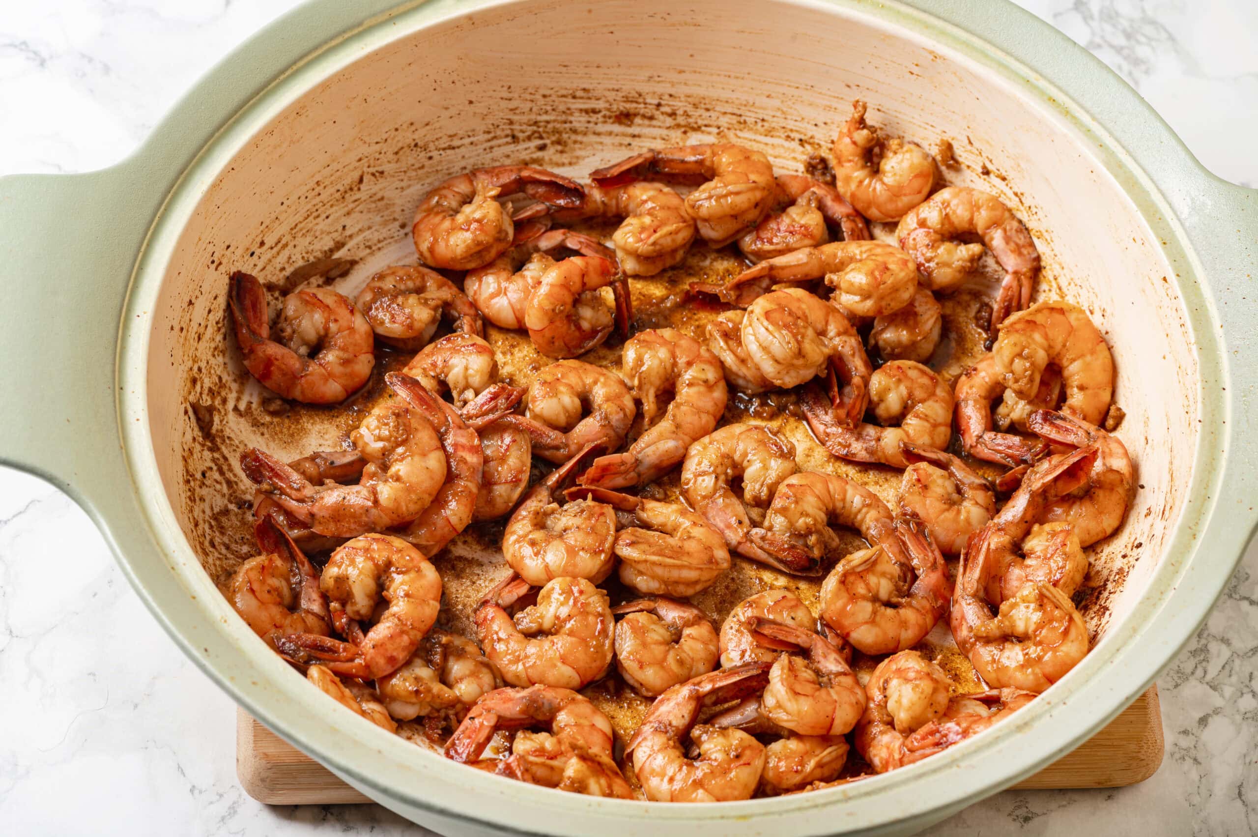 Sauteed shrimp in a skillet.
