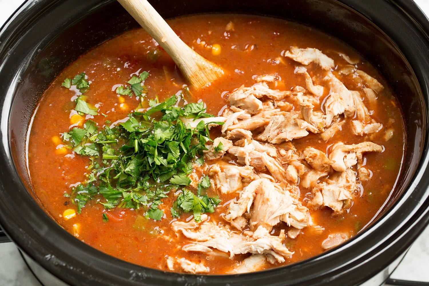 Cooked shredded chicken added back to slow cooker.