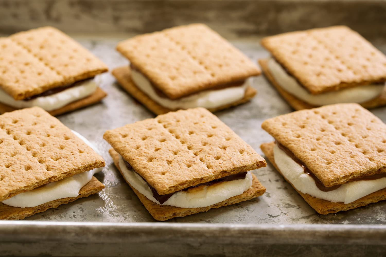 Oven S'mores Second graham cracker layered over toasted marshmallow and chocolate to finish s'mores.