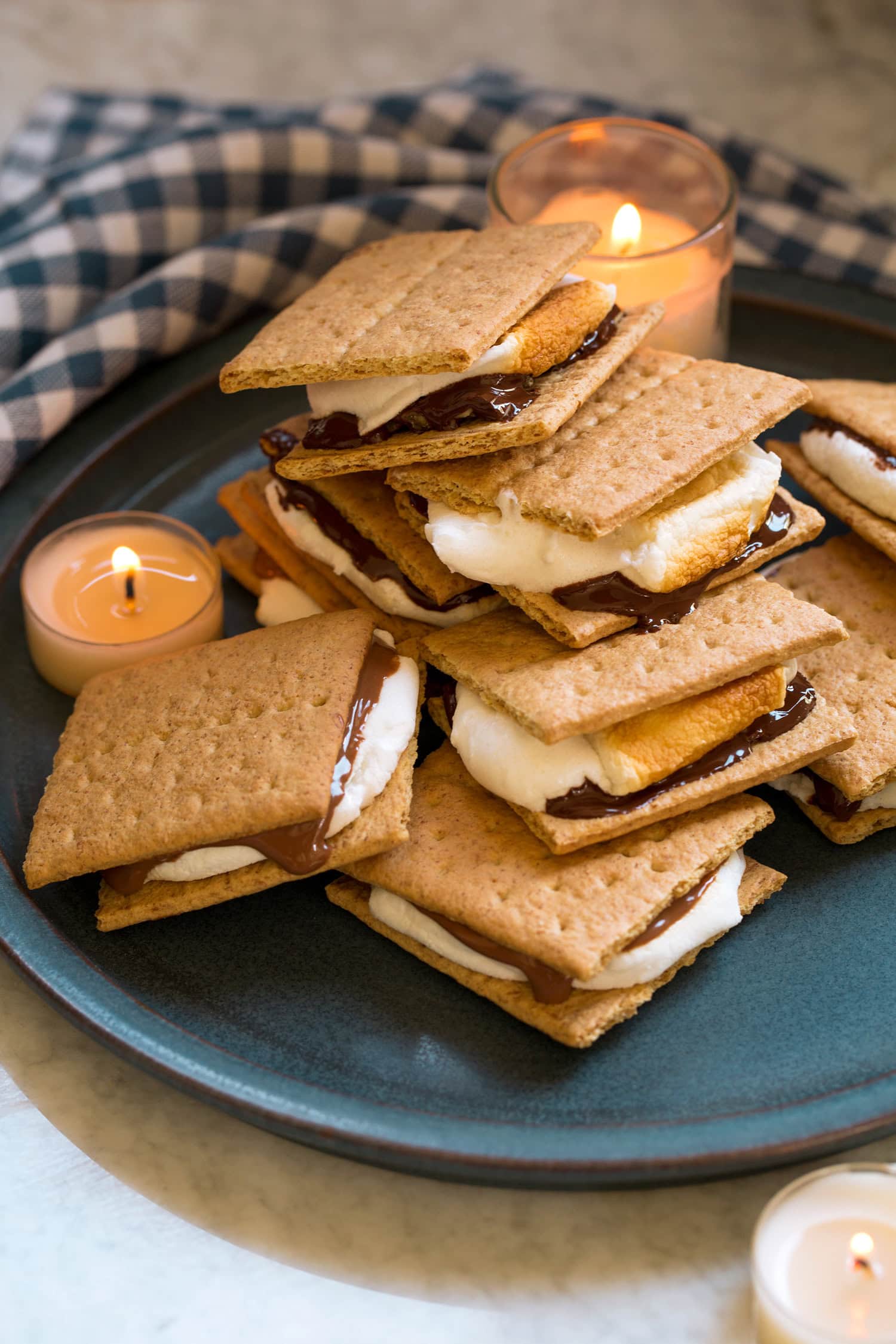 Oven S'mores Pile of s'mores with milk chocolate and dark chocolate on a blue plate.