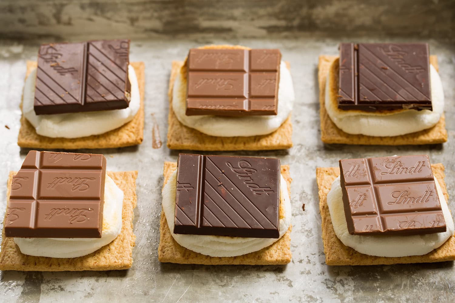 Oven S'mores Chocolate square layered over toasted marshmallows.