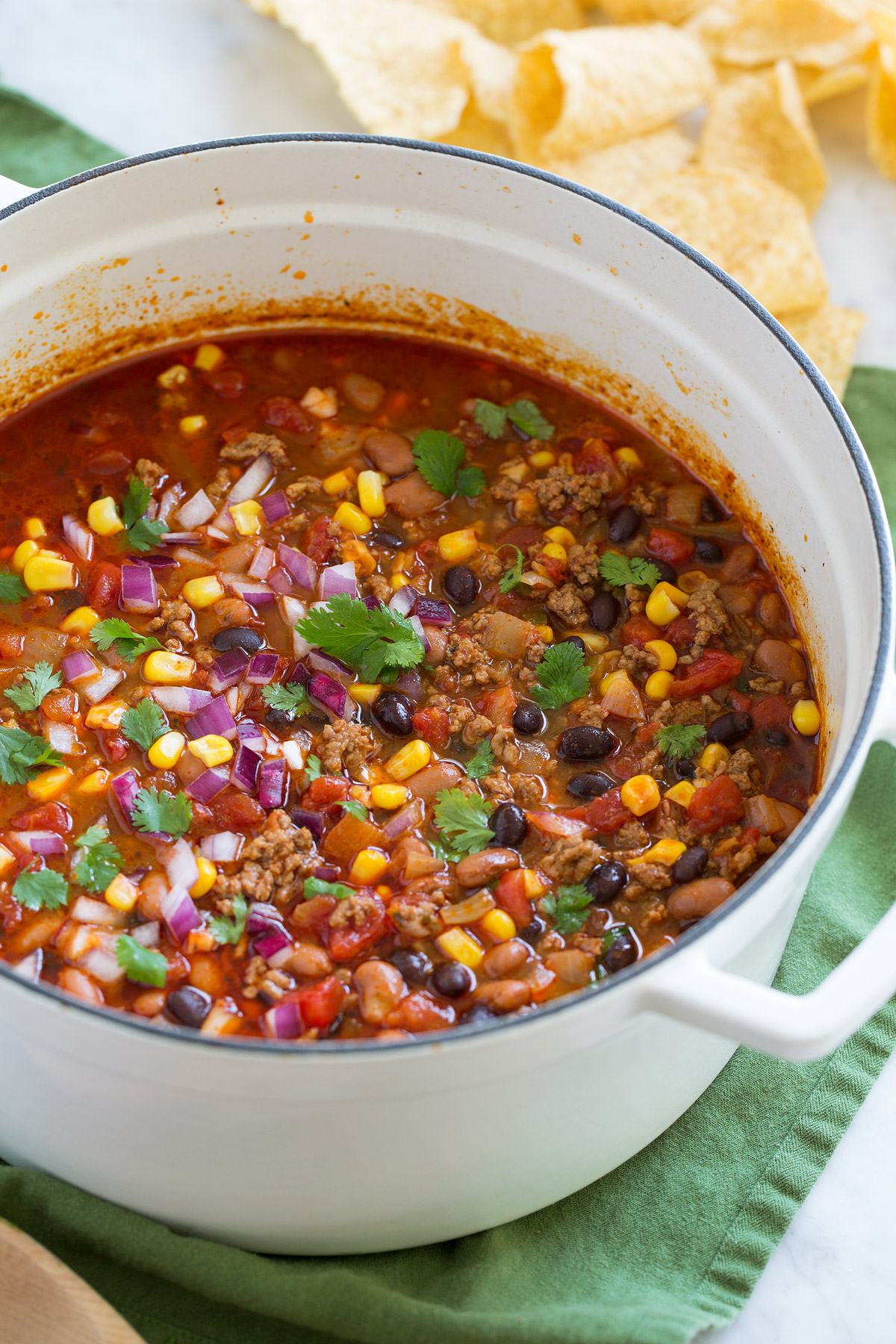Taco Soup - easy, incredibly tasty soup! Loaded with hearty ingredients and brimming with delicious seasoned flavor. Perfect for cold fall and winter days! #tacosoup #soup #fall #recipe White pot full of taco soup.