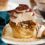 Tiramisu Cupcakes cut into showing interior with soft moist crumb and two flavors.