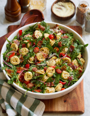 Tortellini pasta salad with four cheese tortellini, arugula, bacon, tomatoes and bell peppers.
