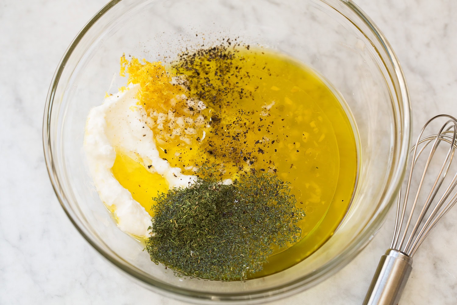 Creamy lemon dressing shown before mixing ingredients.
